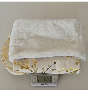 Detail showing plush white Christmas tree skirt with gold foil floral pattern weighing 1342g