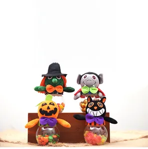 Close-up of Halloween candy jars featuring plush witch, vampire, pumpkin, and black cat designs