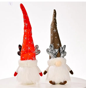 Detail of two glowing Christmas gnomes with reindeer antlers and star pattern hats