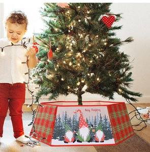 Close-up of red and green plaid Christmas tree collar featuring cute gnomes print