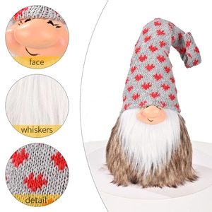 Christmas gnome doll with grey knitted heart hat and plush beard on white background