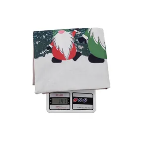 Detail showing Christmas gnome drawstring gift bag on a digital scale weighing 147g