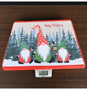 Close-up of a Merry Christmas gnome fabric tree collar being weighed on a digital scale