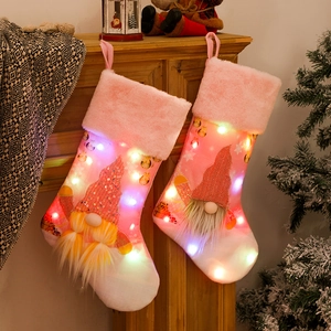 Pink Christmas gnome stockings with LED lights and sequin details for holiday home decor