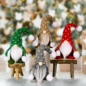 Four Nordic Christmas gnomes with knitted hats and faux fur beards on wooden stools