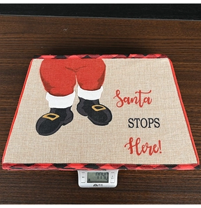 Detailed view of burlap Christmas tree base box showing 114g weight on electronic scale