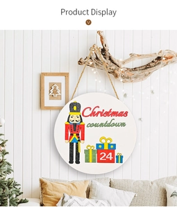 Close-up of a circular wooden Christmas countdown sign with a nutcracker on a wall