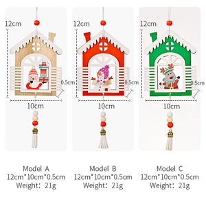 Detailed view of Christmas wooden house ornaments with tassels and holiday character patterns