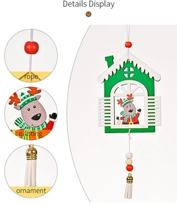 Detail view of wooden Christmas cabin ornament with reindeer print and white tassel