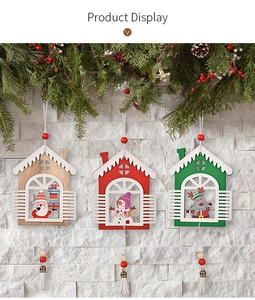 Detail of wooden Christmas house ornaments with Santa, Snowman, and Reindeer motifs