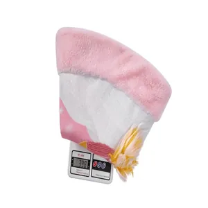 Detail shot showing 398g weight of pink faux fur Christmas tree skirt on a scale
