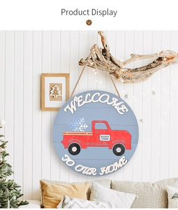 Red farmhouse truck wooden welcome sign with hanging twine on a rustic white wood wall