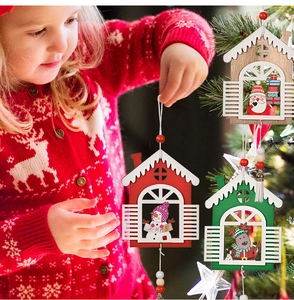 Detailed view of three festive wooden house ornaments with Xmas Santa and snowman figures