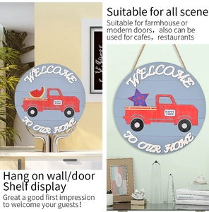 Detail of round wooden door sign with red pickup truck and welcome home message