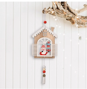 Close-up of wooden Christmas cabin pendant with Santa Claus and tassel details