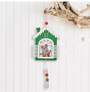 Detail of Christmas wooden pendant with reindeer, forest green finish, and beige tassel