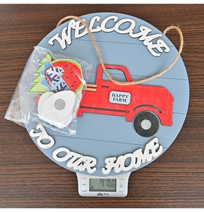 Detail of wooden welcome home sign with red truck and interchangeable seasonal icons