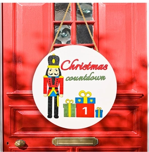 Close-up of wooden Christmas countdown sign with Nutcracker design on red door