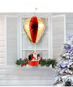 Detail of Santa Claus in hot air balloon hanging ornament with festive holiday decor