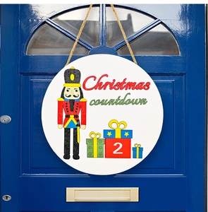 Nutcracker Christmas countdown round door sign with hemp rope on a dark blue front door