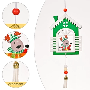 Green wooden house Christmas ornament with reindeer print and white tassel hanging detail