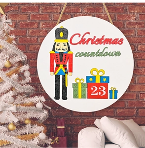 Detail of wooden Christmas countdown plaque featuring Nutcracker and numbered gift boxes
