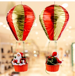 Detail of Santa Claus in a red and gold hot air balloon hanging festive ornament