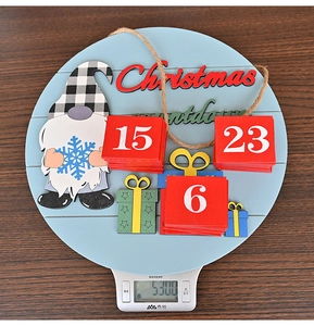 Detail of Christmas countdown calendar gnome sign showing product weight on a scale