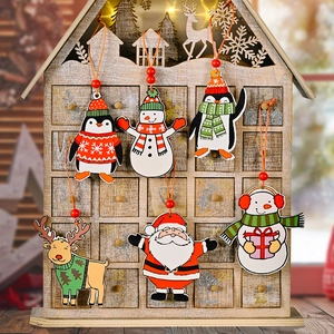 Detail of six hand-painted wooden Christmas tree ornaments with penguin and santa patterns