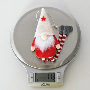 Detailed view of a Christmas gnome ornament weighing 11.3g on a silver digital scale