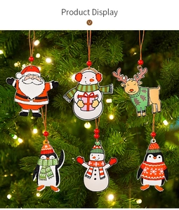 Detailed view of six wooden Christmas ornaments hanging on a lighted tree with red beads