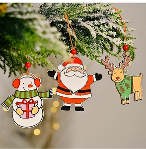 Detail of wooden Christmas tree ornaments featuring Santa, snowman and reindeer figures