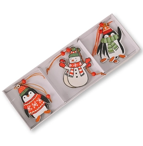 Close-up of wooden Christmas pendants with penguin and snowman designs in a white box