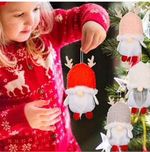 Festive Christmas gnome pendant with plush hat and deer antlers on a decorated tree