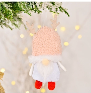 Detail of a Christmas gnome ornament featuring a pink teddy fleece hat with deer antlers