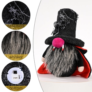 Halloween vampire gnome ornament with LED light, spider web hat, and red cape on white backdrop