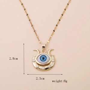 Detail view of gold Evil Eye necklace with dimensions 2.8cm by 2.3cm and 8g weight