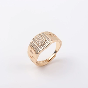 Macro detail of men's gold plated signet ring with micro-paved cubic zirconia and brick texture