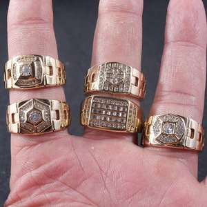 Set of five gold-plated hip hop rings for men with micro-pave zircons on a hand model