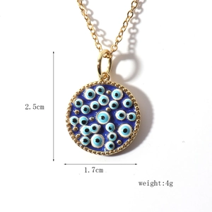 Detail view of gold Evil Eye pendant showing 1.7cm diameter and 2.5cm height dimensions