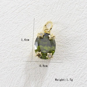 Close-up of olive green zircon pendant with gold star accents and measurements.
