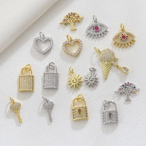 Flat lay of 18k gold plated charms featuring evil eye and heart motifs for DIY jewelry