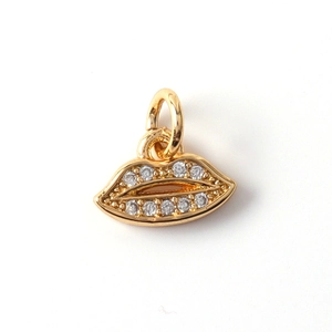 Detailed macro view of a gold-plated lips pendant with micro-pave zirconia stones