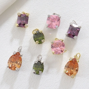 Detail of luxury copper zircon pendants in pear and cushion cuts with gold settings