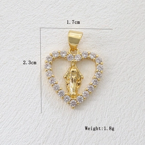 Macro shot of 18k gold plated heart pendant with Virgin Mary and zircon border