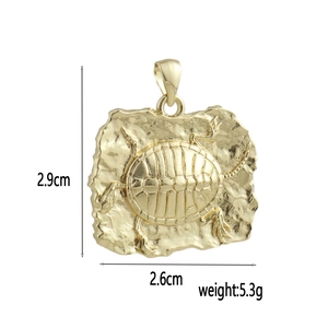 Detailed view of a vintage 18k gold plated turtle pendant with dimensions 2.9cm by 2.6cm