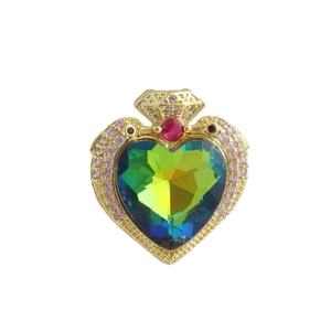 Macro view of heart-shaped gradient gem pendant with pink zircon and gold plating