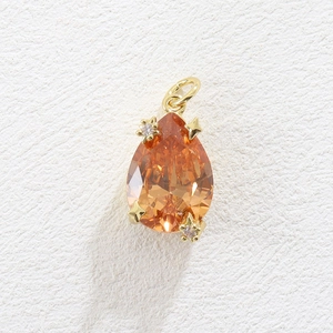 Luxurious pear-cut orange zircon pendant with gold stars and micro-pave accents