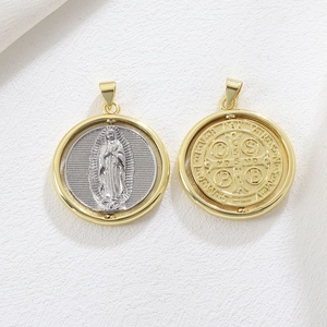 Detailed macro of 18k gold plated Virgin Mary and St. Benedict religious medals