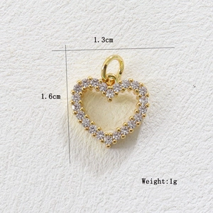 Detailed macro view of 18k gold plated heart pendant with cubic zirconia and dimensions